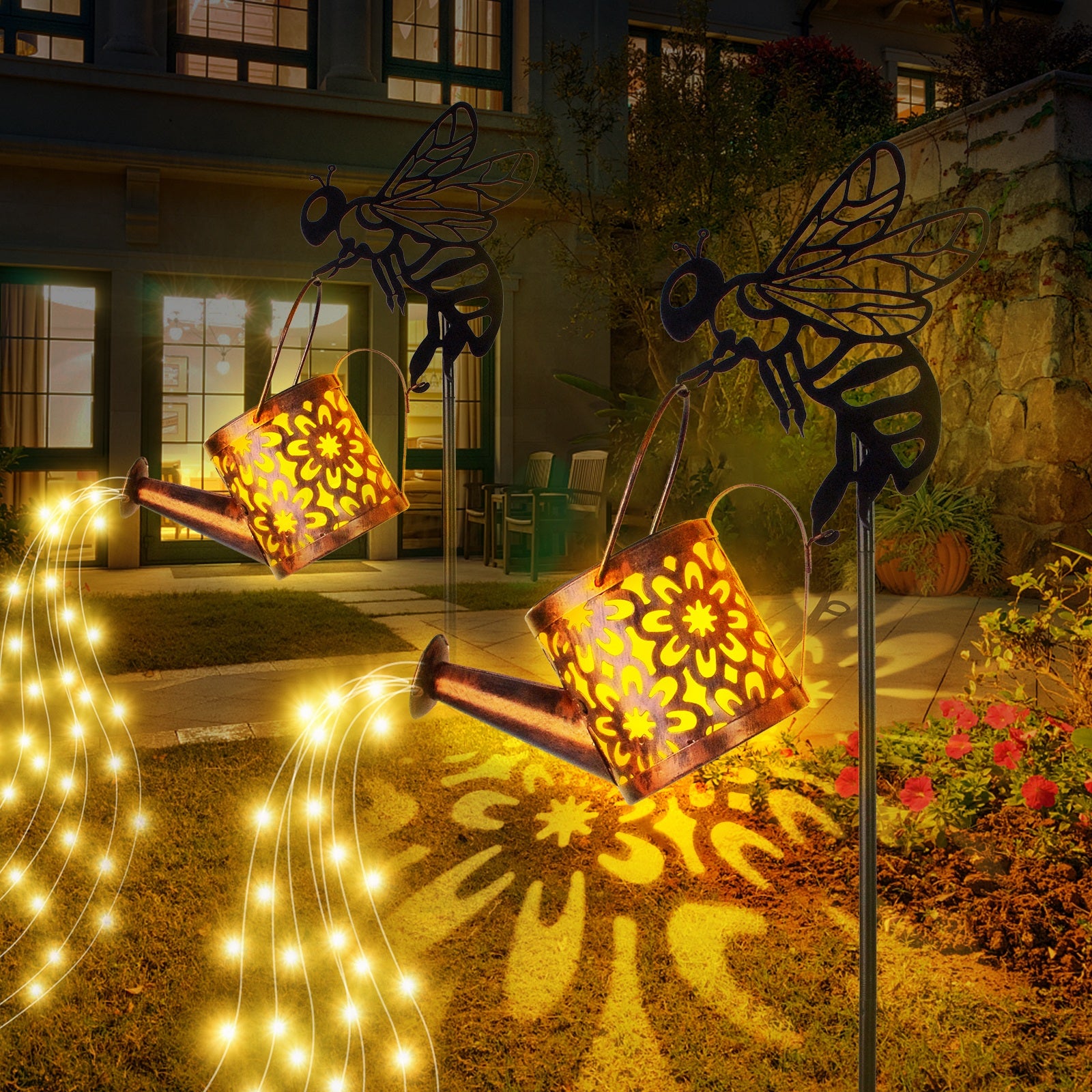 Decorative metal bee sculptures with lanterns and string lights in a garden setting.