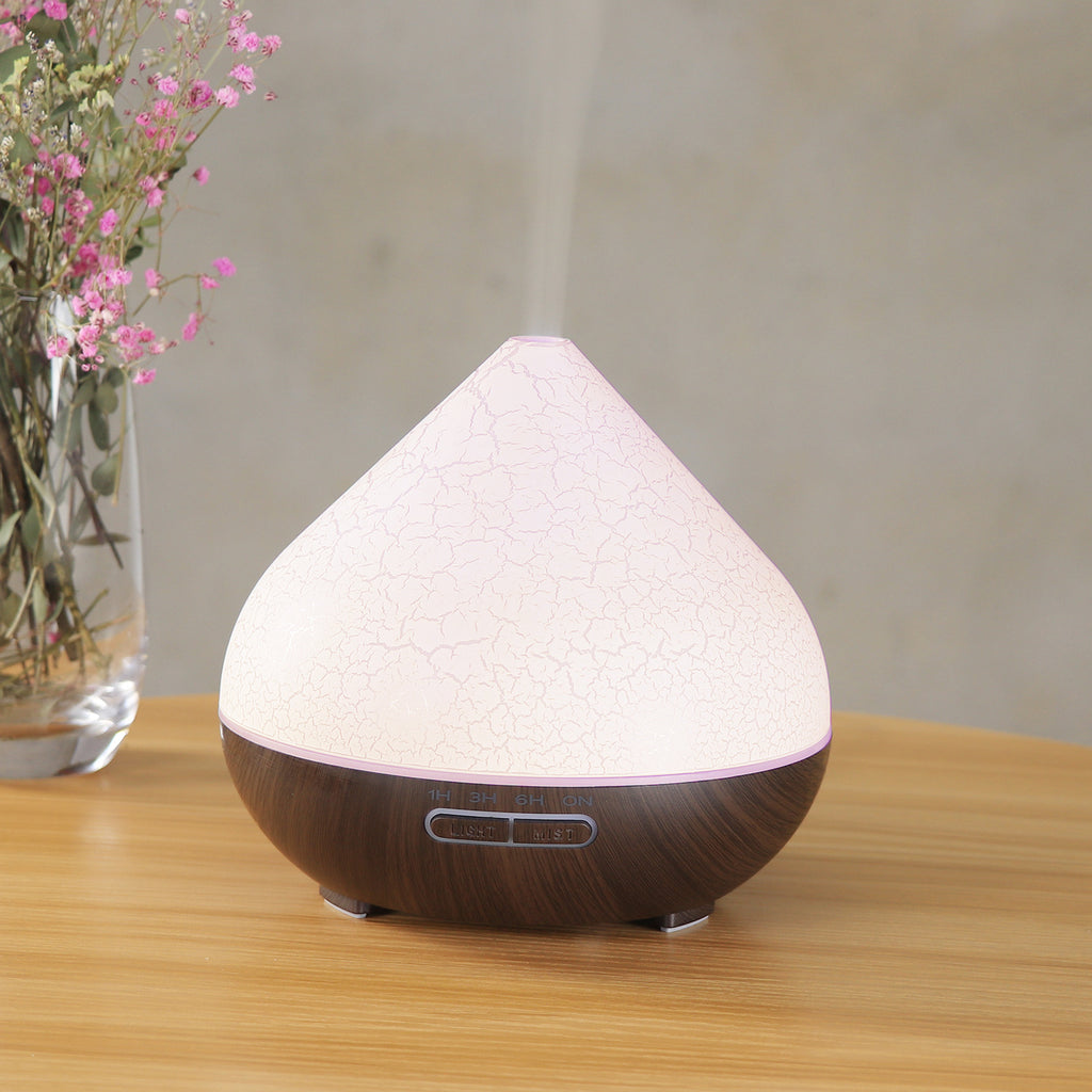 Volcano humidifier in use with essential oil mist and ambient lighting