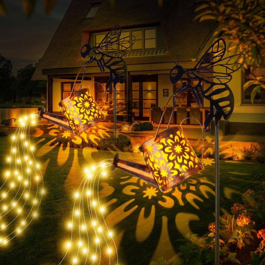 Decorative outdoor lights with butterfly designs casting patterns on a house exterior.