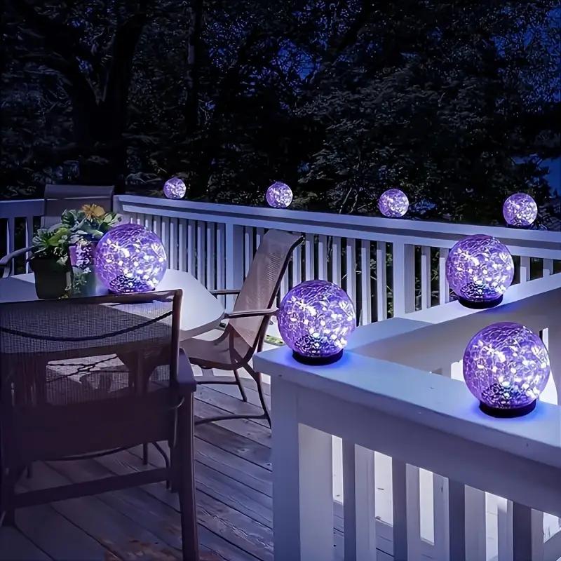 Solar glass ball stake lights creating ambient glow along outdoor walkway