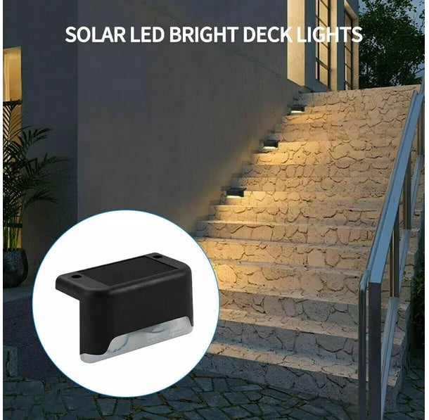 Solar step lights installed on wooden deck stairs showing warm glow